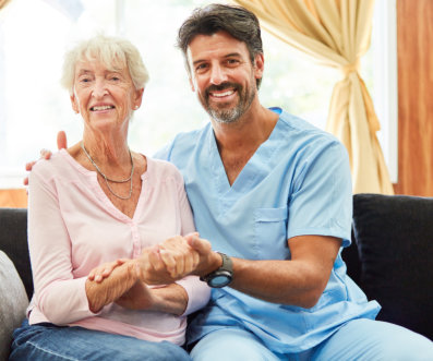 nurse and elderly woman looking at the camera