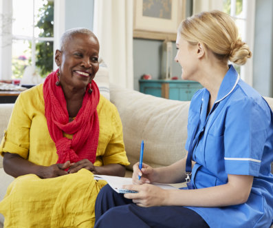 a caregiver talking with a woman