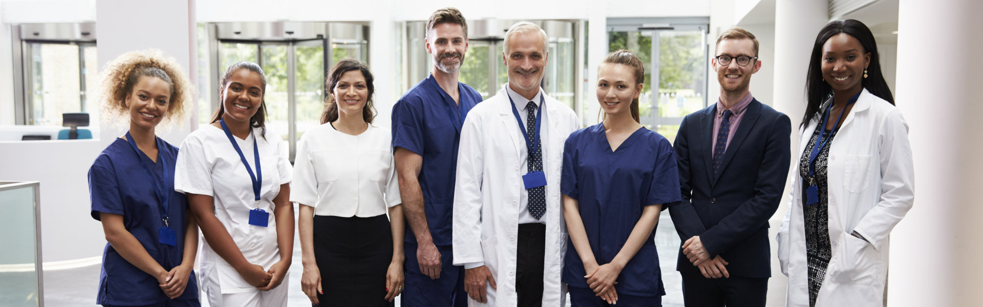 portrait of medical staff standing In lobby of hospital