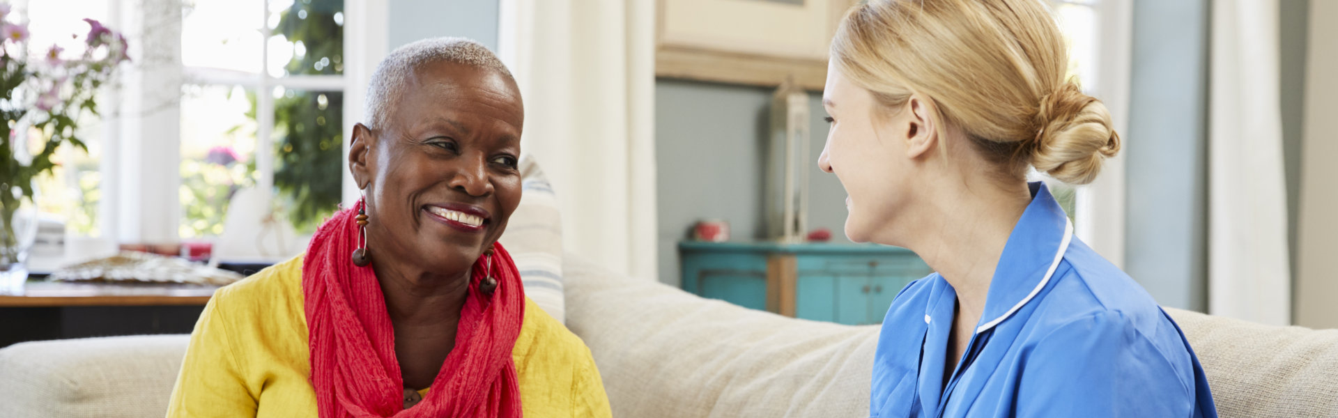 Female Community Nurse Visits Senior Woman At Home